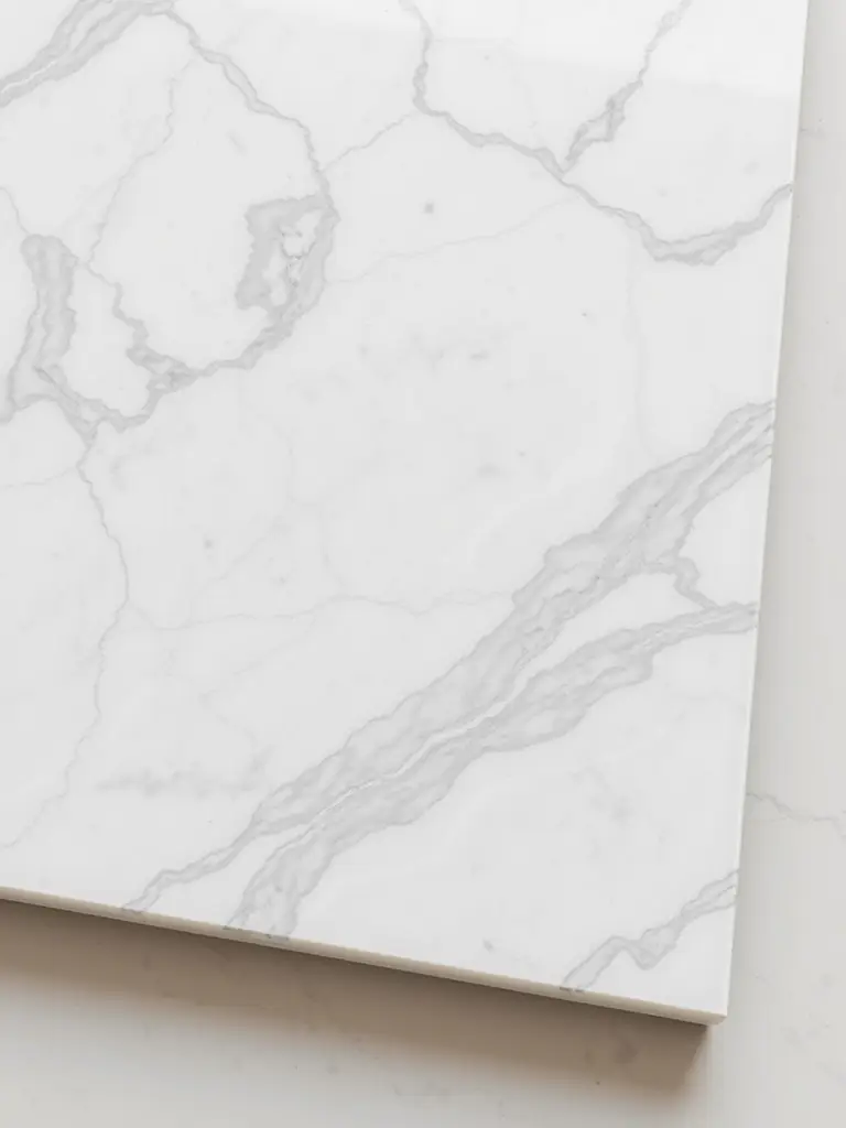 A polished marble countertop highlighting its elegant veining in a bathroom.